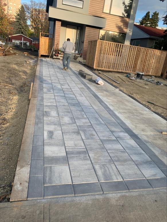 ALA Landscaping crew performing site grading and ground preparation on infill lot